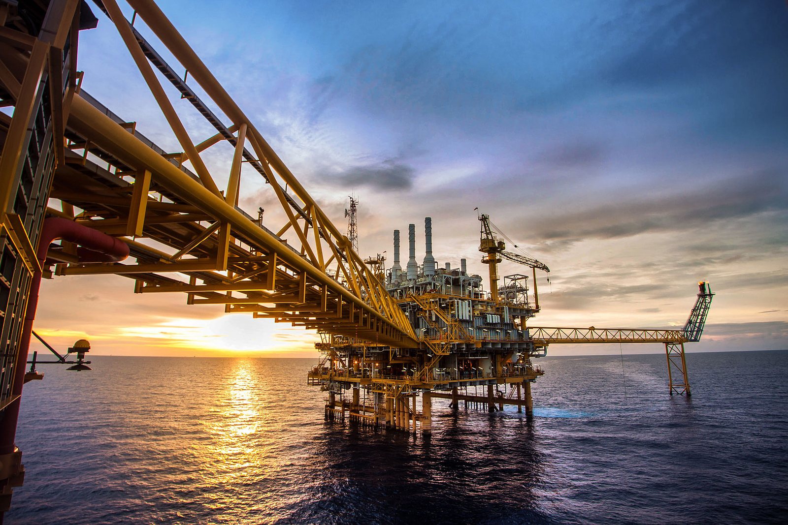 Offshore production platform at sunset
