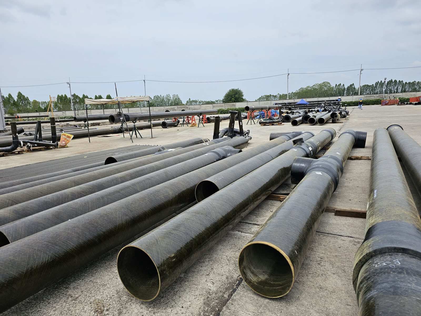 GRE pipe strings laid out on site before jointing