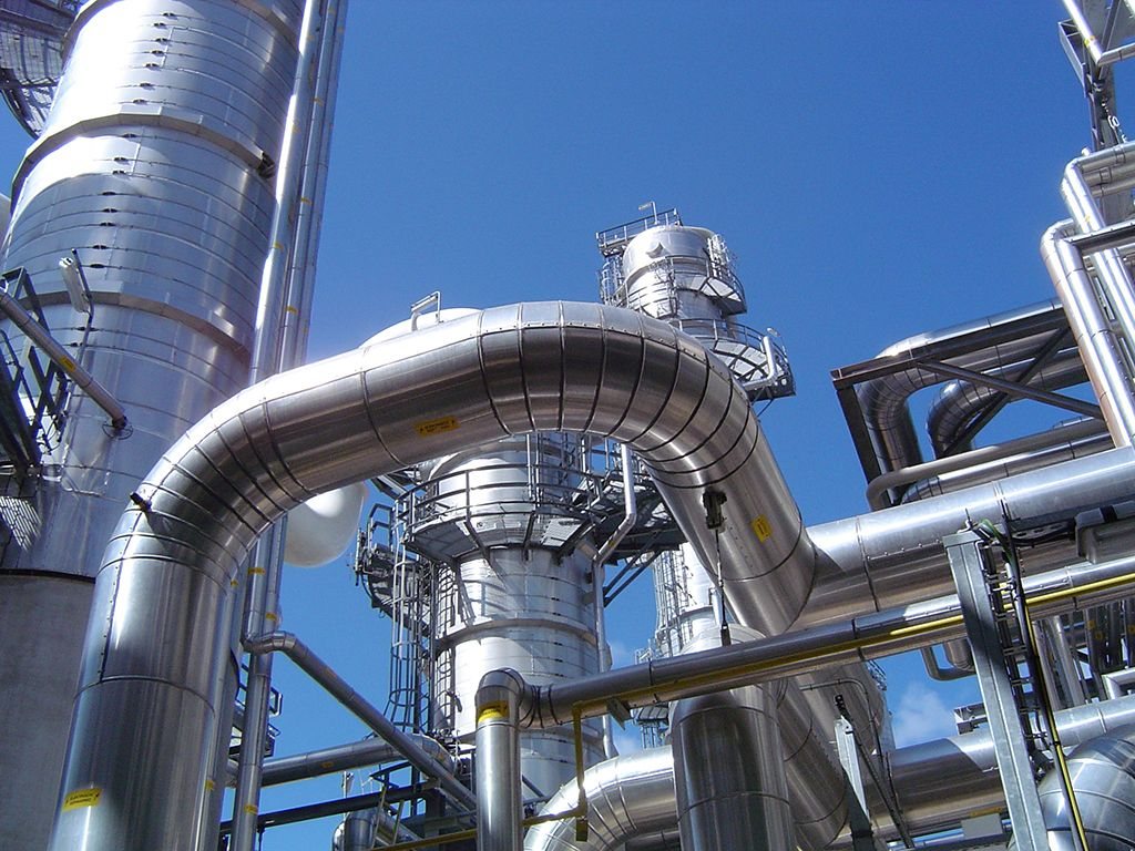 Insulated process piping and equipment at an industrial plant